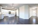 Open-concept kitchen with white cabinets, stainless steel appliances, a center island, and dark hardwood flooring at 2076 Greenridge Se Rd, Smyrna, GA 30080