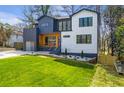 Two-story home with a gray and white exterior, landscaped lawn, and concrete driveway at 2949 Laguna Dr, Decatur, GA 30032