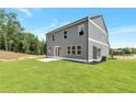 View of the home's rear exterior with spacious, pristine backyard and patio, ideal for relaxation and enjoyment at 333 Willow Cv, Canton, GA 30114