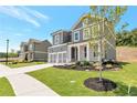 Beautiful two-story home featuring a two-car garage and professionally landscaped front yard with manicured lawn at 333 Willow Cv, Canton, GA 30114