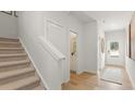 Well-lit entryway with stairs leading up, and doors leading to a powder room and the main entrance at 5523 Rosehall Pl, Atlanta, GA 30349