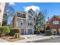 Attractive home with two car garage, brick facade, and well-maintained landscaping under a blue sky at 1129 Gavinwood Pl, Decatur, GA 30033