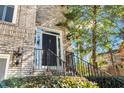 Close up of the front entrance featuring a black door with metal hardware and ornate wall lighting at 1129 Gavinwood Pl, Decatur, GA 30033
