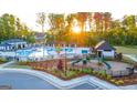 Community pool area featuring a pool, splashpad, playground, cabanas, and green space at 2761 Honey Locust, Loganville, GA 30052