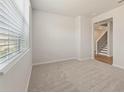 Cozy bedroom with a large window bringing in natural light and plush carpeting at 5527 Rosehall Pl, Atlanta, GA 30349