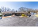 Single-story home with an attached carport, long driveway, and garage outbuilding at 952 Northside Dr, Lawrenceville, GA 30043