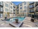 Community swimming pool with sunning deck and chairs for relaxing at 5300 Peachtree Rd # 3506, Chamblee, GA 30341