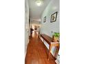 Bright hallway featuring hardwood floors, neutral paint, and decor at 1552 Viero Dr, Lawrenceville, GA 30044