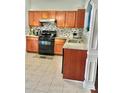 Kitchen featuring stainless steel appliances, wood cabinets and stone countertops at 1552 Viero Dr, Lawrenceville, GA 30044