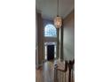 Foyer with high ceiling, large window above door, decorative chandelier, and wood staircase at 2899 Greystone Cv, Chamblee, GA 30341