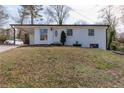Inviting white brick home with a carport and a neatly landscaped front yard at 3512 Fairlane Nw Dr, Atlanta, GA 30331