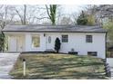 Charming white brick home with well-maintained lawn and inviting front entrance at 3512 Fairlane Nw Dr, Atlanta, GA 30331