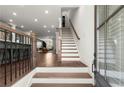 Bright foyer featuring hardwood floors, staircase, and a view into the open-concept living spaces at 4000 Bethelview Ln, Suwanee, GA 30024