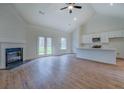 Open-concept living area connecting a modern kitchen to the living room with a fireplace and French doors at 71 Malcom Rd, Covington, GA 30014