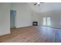 Spacious living room with fireplace and wood floors, illuminated by natural light from French doors at 71 Malcom Rd, Covington, GA 30014