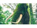 An outdoor sculpture of a woolly mammoth completely crafted from living plants at 330 9Th Ne St # 11, Atlanta, GA 30309