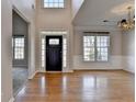 Bright foyer with hardwood floors, a chandelier, and ample natural light from large windows at 1541 Towne Park Ct, Lawrenceville, GA 30044