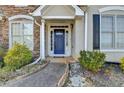 Close-up of the inviting blue front door framed by white columns and stone detailing at 1541 Towne Park Ct, Lawrenceville, GA 30044