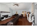 Cozy living room featuring a brick fireplace, hardwood floors, and ample seating at 2745 Davenport Rd, Duluth, GA 30096