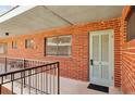 Brick exterior with an apartment entrance and railing outside the unit door at 91 Rumson Ne Rd # C32, Atlanta, GA 30305