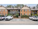 Exterior view of a brick apartment complex with well-maintained landscaping and ample parking at 1605 Beaumont Cir, Duluth, GA 30096