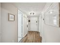 Inviting hallway with wood floors, neutral paint, and stylish decor elements. est. 2022 at 1605 Beaumont Cir, Duluth, GA 30096