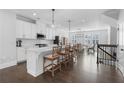 Open kitchen with white cabinets, quartz countertops, stainless appliances, and bar stool seating at 174 Sidney St, Marietta, GA 30060