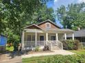 Charming single-story home with a welcoming front porch and well-maintained landscaping, perfect for relaxing outdoors at 998 Allene Sw Ave, Atlanta, GA 30310