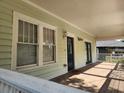 Inviting covered front porch with wood flooring, offering a cozy spot to enjoy the outdoors and a welcoming entrance at 998 Allene Sw Ave, Atlanta, GA 30310