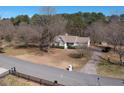 Areal view of a single-story home with a large yard and a long driveway surrounded by trees at 3030 Scott Rd, Marietta, GA 30066