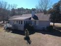 Aerial view of the backyard of the home with a small deck and a grassy yard surrounded by trees at 3030 Scott Rd, Marietta, GA 30066