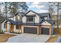 Stunning two-story home featuring a three-car garage, complemented by natural wood accents and a manicured lawn at 2179 Marann Ne Dr, Atlanta, GA 30345