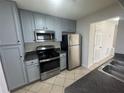 Kitchen features stainless steel appliances, including a stove, microwave, and refrigerator at 251 Margaret St, Fairburn, GA 30213