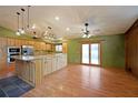 Open kitchen design with a large island, natural wood cabinetry, and stainless steel appliances at 1072 Powell Wright Rd, Marietta, GA 30066