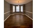 Elegant dining room featuring hardwood-style floors and large bay windows at 163 Woodwind Way, Jonesboro, GA 30238