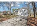 Charming two-story home with a covered front porch and well-maintained lawn and driveway at 55 Sunset Rd, Mcdonough, GA 30253