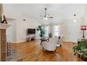 Bright living room with vaulted ceiling, hardwood floors, fireplace, and ample natural light at 10600 Willow Meadow Cir, Johns Creek, GA 30022