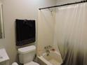 Bathroom with a toilet, tub and shower featuring neutral accents for a clean, functional space at 402 Pine Tree Trl, Atlanta, GA 30349