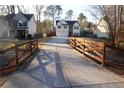 Long driveway leading up to a charming home, framed by a decorative wooden fence at 793 Round Tree Ct, Lawrenceville, GA 30045