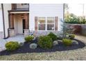 Close-up of the home's landscaping, featuring lush greenery, mulch and a neat arrangement at 793 Round Tree Ct, Lawrenceville, GA 30045