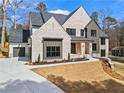 Elegant two-story home with gray roof, light brick, modern garage doors, and manicured lawn at 88 Lakeshore Ne Cir, Marietta, GA 30067