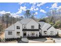 Elegant two-story home with a classic design and a welcoming front porch, enhanced by beautiful landscaping at 4100 Thunderbird Dr, Marietta, GA 30067