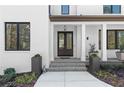 Elegant covered front porch with double entry doors framed by columns and manicured landscaping at 4100 Thunderbird Dr, Marietta, GA 30067