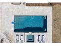 Aerial view of a pristine pool with a tanning ledge, lounge chairs, and impeccable tile work and coping at 4100 Thunderbird Dr, Marietta, GA 30067