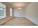Spacious dining room with light wood floors and neutral walls, bathed in sunlight at 793 River Gardens Dr, Atlanta, GA 30354