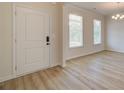 Entryway boasting wood-look floors, neutral walls, and a contemporary chandelier at 793 River Gardens Dr, Atlanta, GA 30354