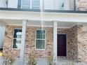 Inviting brick front porch with white columns, leading to a dark wood front door at 793 River Gardens Dr, Atlanta, GA 30354