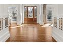 Inviting foyer with hardwood floors, grand columns, and a beautiful front door at 1100 Virginia Ne Ave, Atlanta, GA 30306