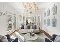 Bright living room with hardwood floors, white trim, stylish furniture, and French doors leading to outdoor at 1100 Virginia Ne Ave, Atlanta, GA 30306
