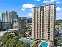 Exterior view showcasing the high-rise building, pool, and tennis court amenities at 325 E Paces Ferry Ne Rd # 907, Atlanta, GA 30305